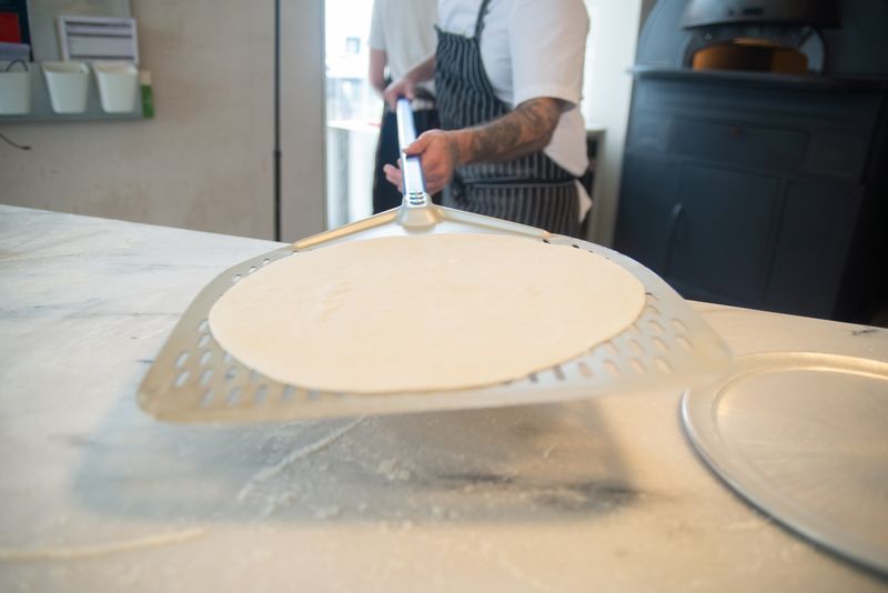 Anthony's coal fired pizza team working together in restaurant kitchen